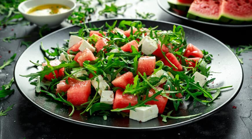Fresh Juicy Watermelon arugula Feta salad with mint and orange, lemon dressing. summer dish. healthy food